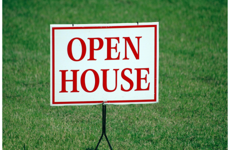 Open House sign red font on white grass in backgrouns