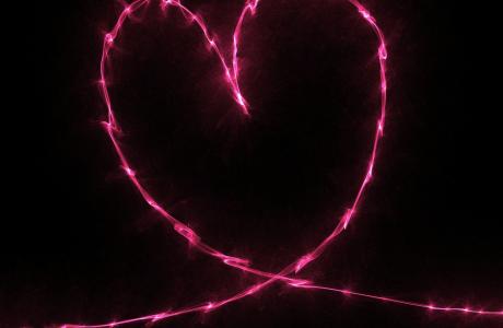 neon pink heart on black background