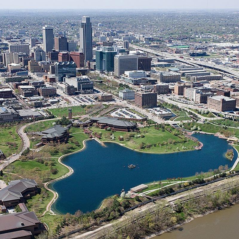 aerial view of downtown Omaha with lake, grassy area and tall buildings