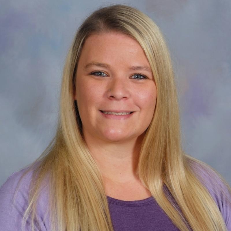 Photo of Courtney Bergmann-Hansen wearing a purple shirt and lavender sweater