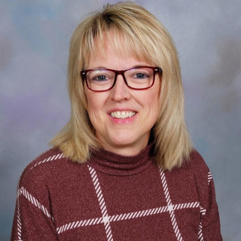 Photo of Kathleen Patten wearing a maroon striped shirt