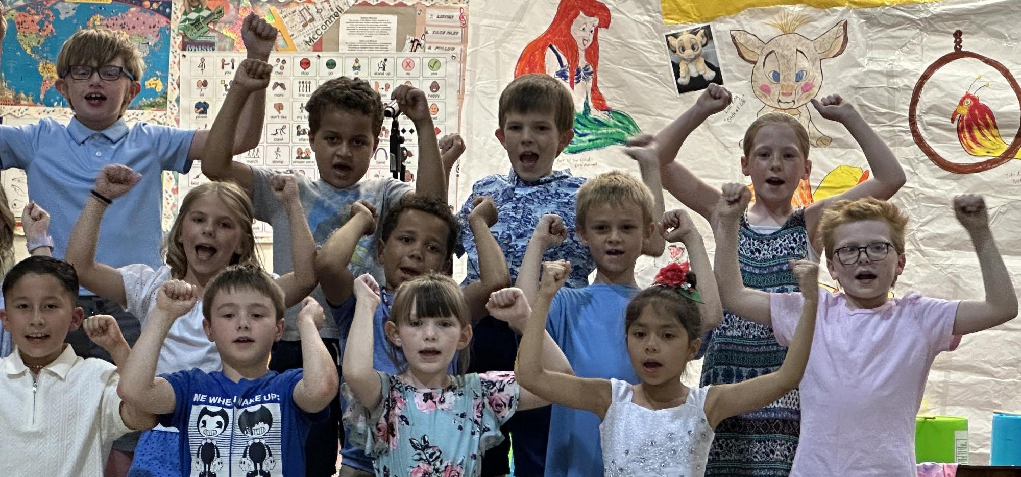 students singing with raised arms