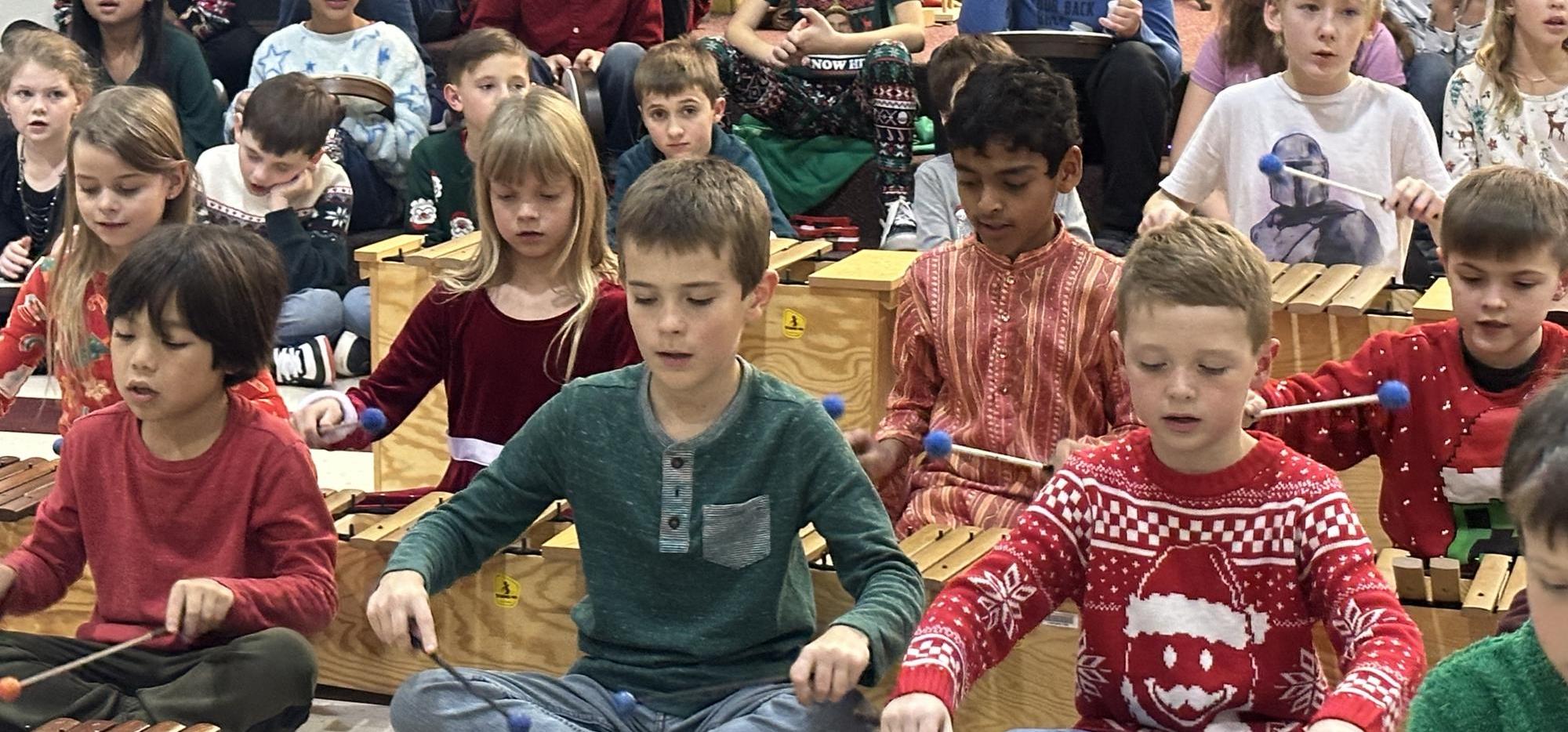 children playing xylophones and Orff instruments